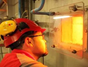 Recovering waste: technician in front of an incinerator